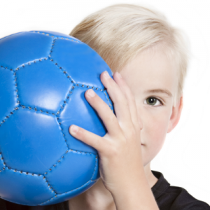 'child behind soccer ball'